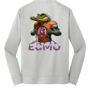 May include: A light gray sweatshirt featuring a detailed illustration of an alligator wearing an orange and blue football jersey, revealing a human heart. The word "ECMO" is displayed in a stylized font below the alligator.