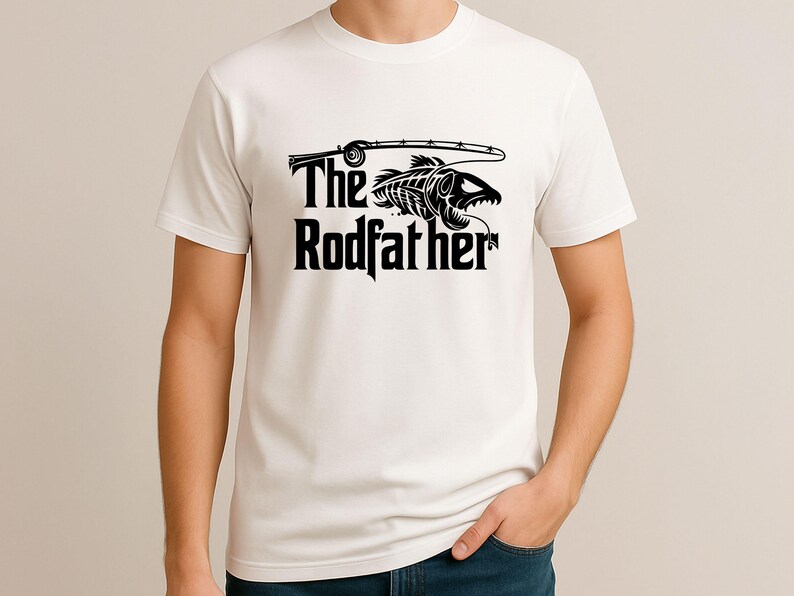 Puede incluir: Camiseta blanca con un dise&ntilde;o gr&aacute;fico negro. El dise&ntilde;o presenta una ca&ntilde;a de pescar, un esqueleto de pez y las palabras "The Rodfather" en negrita y con un estilo llamativo. La camiseta es de manga corta y parece ser de algod&oacute;n.