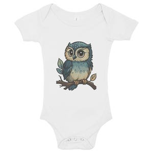 May include: White baby onesie featuring a cartoon owl illustration. The owl is perched on a branch with leaves, showcasing blue, green, and brown tones. The onesie has short sleeves and snap closures at the bottom.