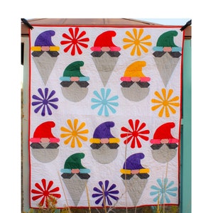 May include: A quilt pattern featuring a gnome design with a variety of colors, including red, green, purple, yellow, and blue. The quilt is 50 inches by 60 inches and is titled "Gnome Follies".