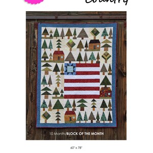 May include: A quilt block pattern featuring a red, white, and blue American flag surrounded by green trees and houses. The quilt block is 60 inches by 78 inches and is part of a 10-month block of the month program. The pattern is called "American Country" and is designed by Charisma Horton.