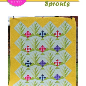 May include: A quilt pattern called "Sprigs & Sprouts" by Charisma Horton. The quilt is a patchwork of green, yellow, pink, red, blue, and white squares and triangles. The quilt is 76 inches by 93 inches.