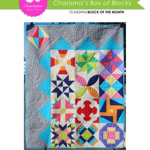 May include: A colorful quilt with a variety of geometric patterns in shades of red, blue, green, yellow, and white. The quilt is made up of 15 blocks and is 48 inches by 60 inches. The quilt is titled "Charisma's Box of Blocks" and is a 15 month block of the month project.