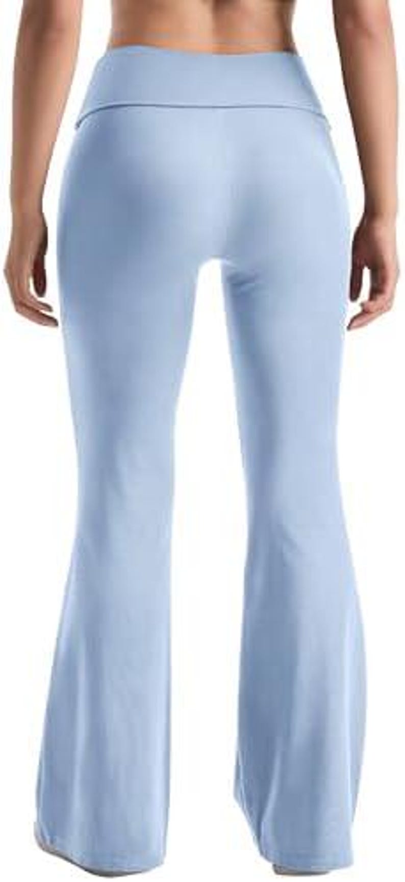 Light blue flared yoga pants. The pants have a high waistband and a flared leg design. The fabric appears to be soft and stretchy, suitable for yoga or other activities. The pants are shown from the back.