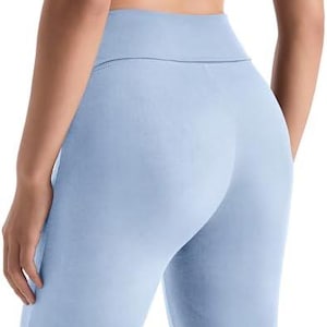 Light blue leggings with a high waistband. The leggings are made of a soft, stretchy material and are designed for comfort and flexibility. The leggings are a solid color and have a streamlined fit.