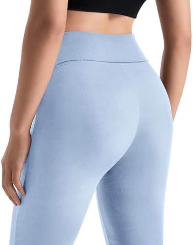 Light blue leggings with a high waistband. The leggings are made of a soft, stretchy material and are designed for comfort and flexibility. The leggings are a solid color and have a streamlined fit.