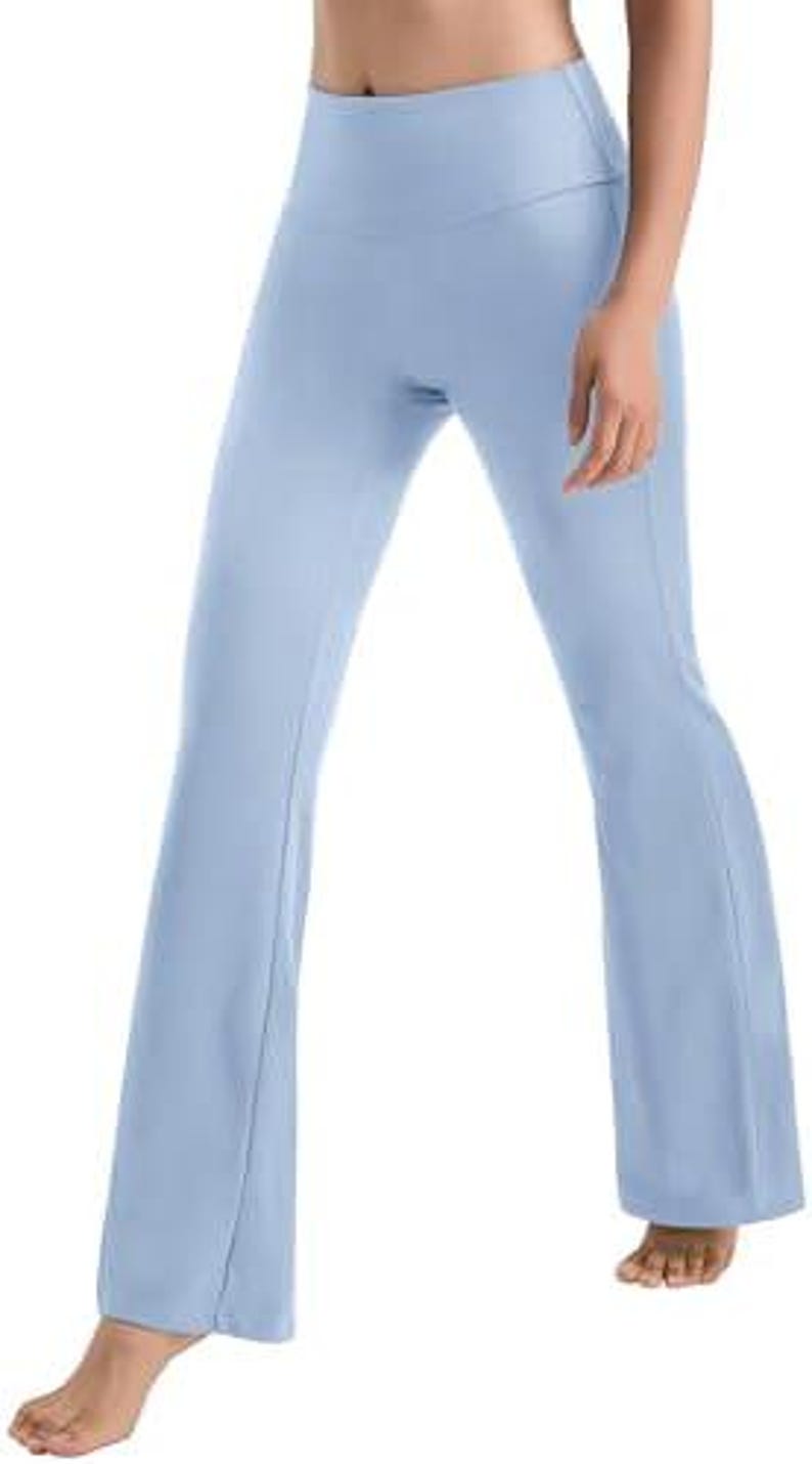 Light blue yoga pants with a high waistband and flared legs. The pants are made of a soft, stretchy material and are designed for comfort and flexibility during workouts or everyday wear.