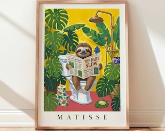 May include: A framed art print featuring a brown sloth sitting on a white toilet, reading a newspaper titled THE DAILY SLOW. The scene is surrounded by green monstera leaves, a brass shower fixture, and toilet paper rolls. The word MATISSE is at the bottom.