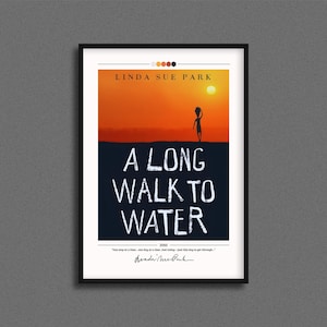 May include: Framed art print of "A Long Walk to Water" by Linda Sue Park. The artwork features a silhouette of a person walking towards a sun against an orange and blue background. The title is in white, bold letters.