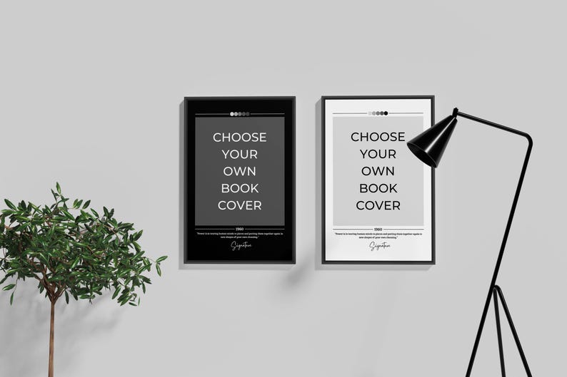 May include: Two black framed posters with white text that reads "Choose your own book cover" on a white wall. A black floor lamp is in the right corner of the image.