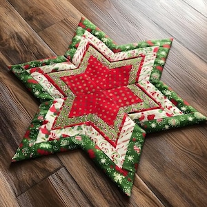May include: A star-shaped quilted fabric mat featuring a central red section with gold polka dots, surrounded by layers of green fabric with white snowflake patterns, red and white candy cane stripes, and small red floral motifs in a geometric design.