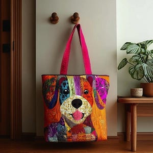May include: A colorful patchwork tote bag featuring a dog design. The bag has a bright pink handle and a variety of fabric patterns in shades of orange, purple, blue, and yellow. The dog's face is the focal point.