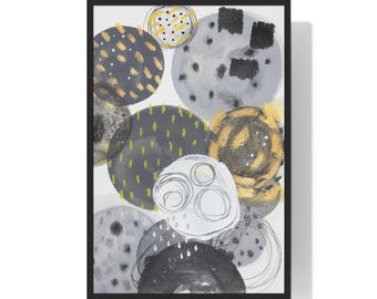 May include: Abstract art print featuring overlapping circles in shades of gray, black, and gold. Some circles have dotted or textured patterns, while others have freehand lines. The artwork is framed in a black frame.