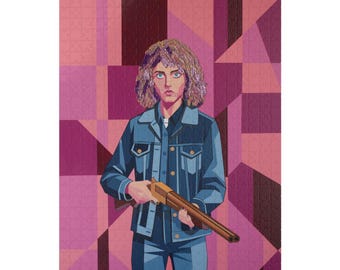 May include: A jigsaw puzzle featuring a stylised illustration of a person with curly hair wearing a blue denim jacket and holding a shotgun. The background consists of geometric shapes in various shades of pink, magenta, and deep purple.