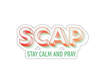 May include: A die-cut sticker featuring the acronym SCAP in a bold, layered, orange and green halftone font. Below the acronym, the text STAY CALM AND PRAY is printed in a clean, green sans-serif typeface against a white background.