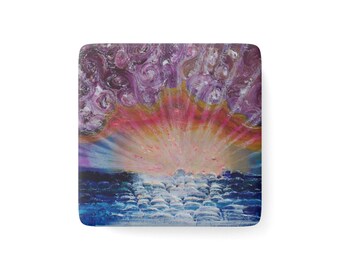 May include: A square coaster featuring an abstract painting of a sunrise over a dark blue ocean. The sky transitions from deep purple swirls at the top to a bright orange and yellow sunburst radiating light across the centre of the horizon.