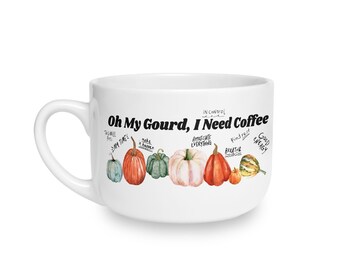 May include: A white ceramic mug featuring a row of watercolour-style pumpkins in shades of orange, green, and white. Above the pumpkins, the black text reads "Oh My Gourd, I Need Coffee," with smaller handwritten phrases like "My Time" and "Good Energy."
