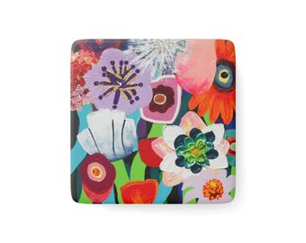 May include: A square coaster featuring a vibrant, multi-coloured floral painting. The design includes stylised flowers in shades of purple, orange, red, white, and green, with thick, textured brushstrokes and a glossy finish on the surface.