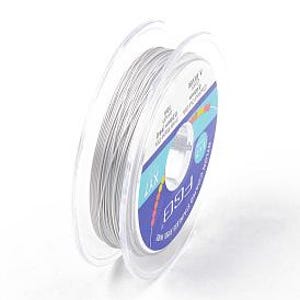 May include: A spool of clear, elastic beading cord. The cord is wound around a transparent plastic spool with a blue and white label. The label includes text and measurements. The cord is 0.8mm in diameter.