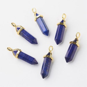 May include: Six gold-toned pendant charms featuring blue lapis lazuli stones in a pointed shape. The charms are perfect for jewelry making.