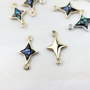 May include: Gold and silver tone star-shaped connector charms with abalone shell inlay. The charms have two jump rings for attaching to jewelry.