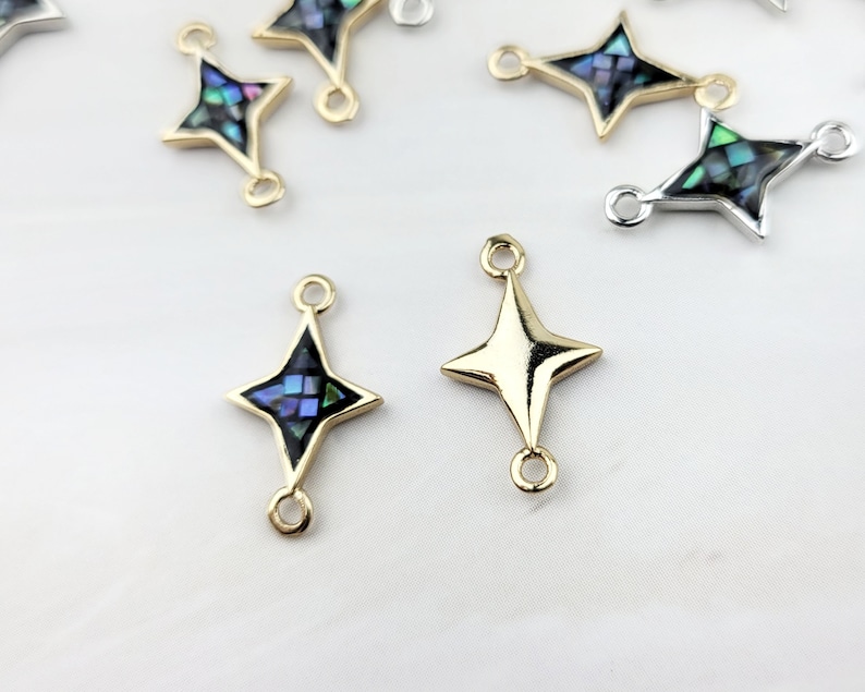 May include: Gold and silver tone star-shaped connector charms with abalone shell inlay. The charms have two jump rings for attaching to jewelry.