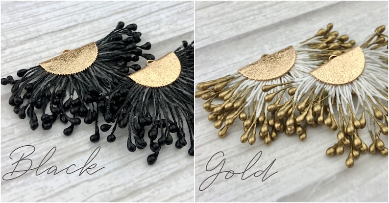 May include: A pair of dangle earrings with a gold half-circle base and black or gold teardrop-shaped beads. The earrings are shown against a white wood background. "Black" and "Gold" are written below the earrings.