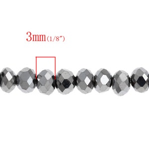 May include: A strand of silver-toned faceted glass beads, each bead measuring 3mm (1/8 inch) in diameter.