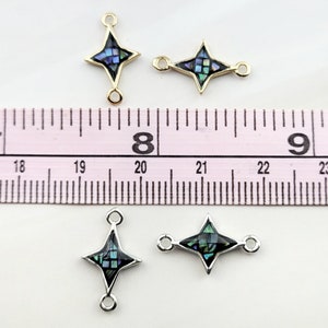 May include: Three gold and silver tone star-shaped connector charms with abalone shell inlay. The charms are approximately 1 inch in length and have two jump rings on each charm.