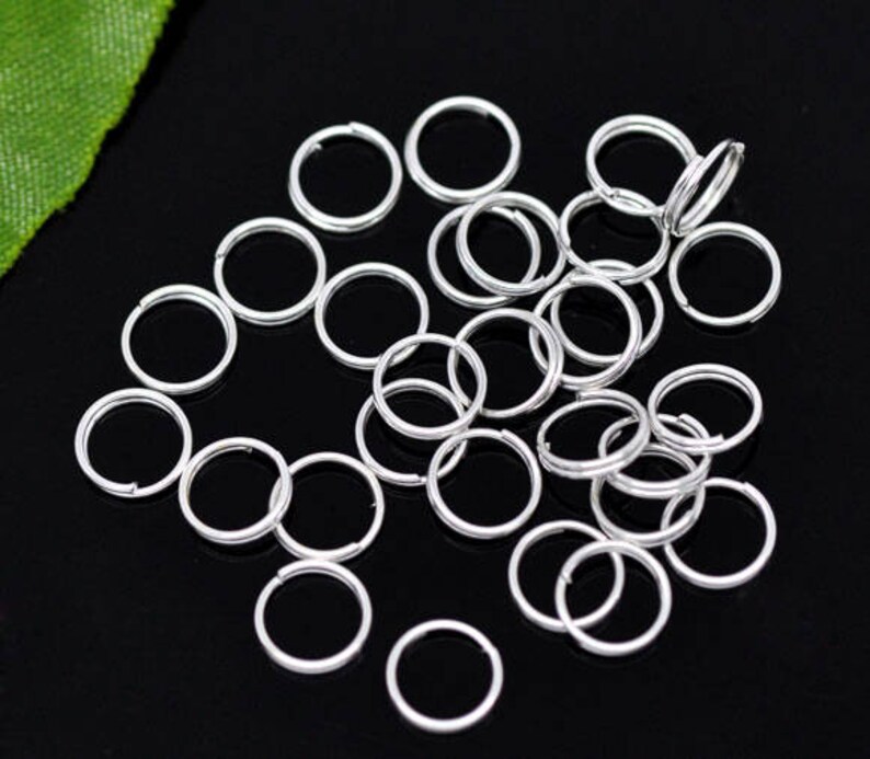 May include: A large quantity of silver jump rings, ideal for jewelry making or crafting projects.