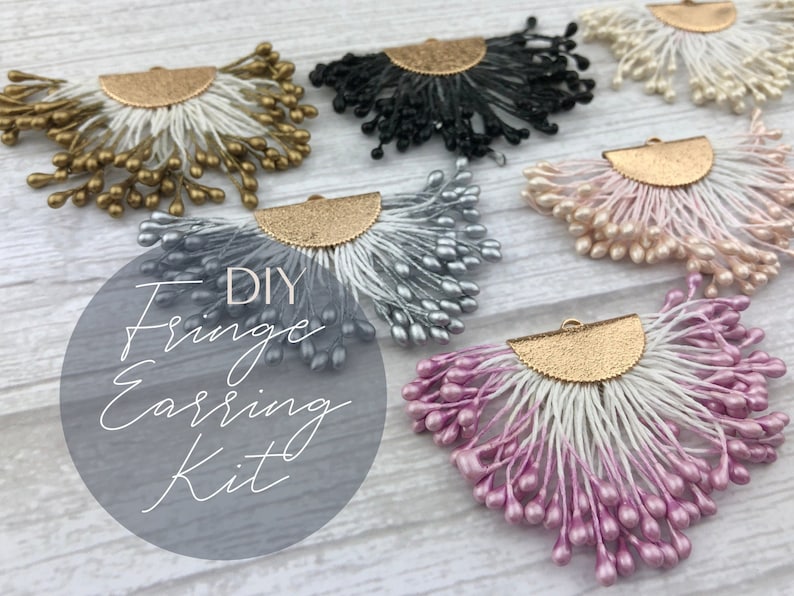 May include: DIY Fringe Earring Kit with six pairs of earrings in various colors, including gold, silver, black, pink, and white. The earrings are made with small, round beads and have a gold metal base.