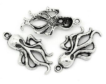 May include: Three silver-toned octopus charms with intricate details. Each charm features a different design of an octopus with multiple tentacles.