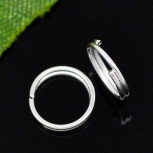 May include: Two silver key rings, one is a single ring and the other is a double ring.