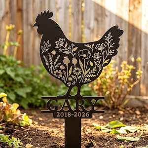 May include: A black metal garden stake shaped like a chicken silhouette with intricate floral cutouts. The base features the name GARY in bold capital letters, followed by the years 2018-2026, all supported by a single vertical ground spike.