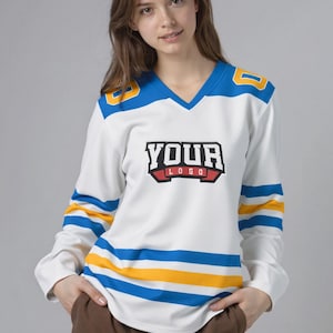 May include: White hockey jersey with blue and yellow detailing. The jersey features a V-neck and long sleeves with blue and yellow stripes. The text "YOUR LOGO" is displayed on the front. The shoulders have the number "8" in yellow.