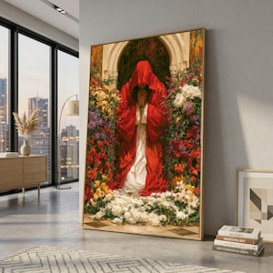 Pode incluir: Uma impressão de arte emoldurada retrata uma figura com uma capa vermelha com capuz, com as mãos juntas em oração, rodeada por flores coloridas. A obra de arte tem um estilo clássico, com foco na luz e sombra.