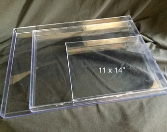 May include: Three clear plastic display boxes, nested inside each other. The largest box measures 11 inches by 14 inches.