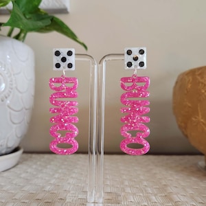 May include: A set of three ceramic canisters with lids. The canisters are white with a blue floral pattern. The largest canister is 8 inches tall, the medium is 6 inches, and the smallest is 4 inches.