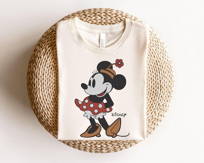 a mickey mouse shirt sitting on top of a wicker basket