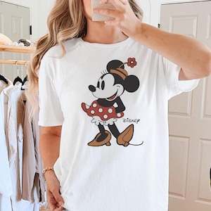 a woman taking a selfie in front of a mirror