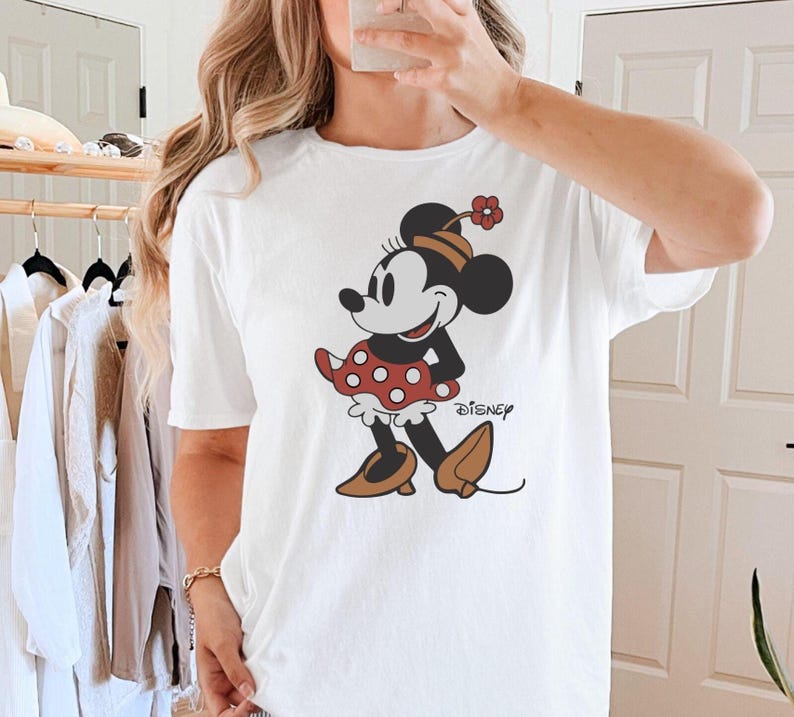 a woman taking a selfie in front of a mirror