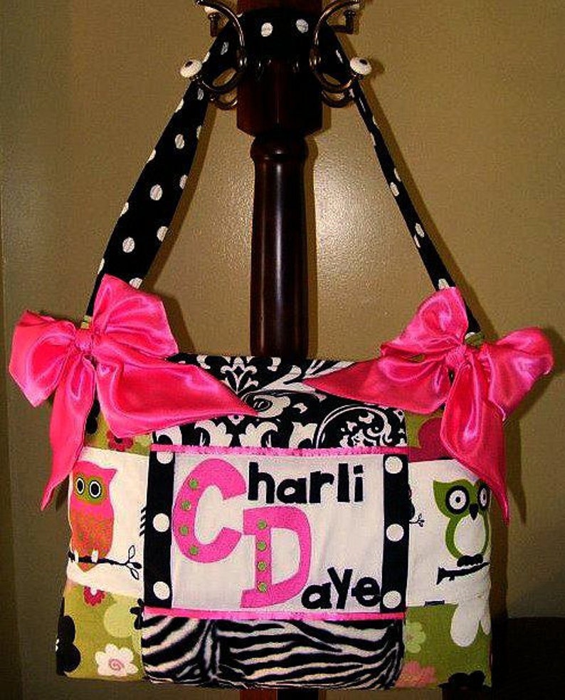 green and black diaper bag