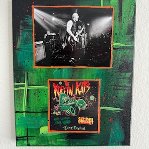 May include: A canvas art piece featuring two framed images. The top image is a black and white concert photo. The bottom image is a graphic with the text "The Koffin Kats" and "Cut-Rate Druggist". The background is green with black and red paint splatters.
