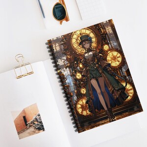 May include: Spiral-bound notebook with a steampunk illustration. The cover depicts a woman in Victorian attire against a backdrop of clocks and gears. The colour scheme includes gold, brown, green, and blue. The notebook rests open on a white surface with a gold paper clip.