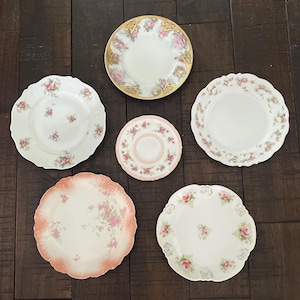 May include: A white ceramic mug with a black handle and the text "But First, Coffee" in a bold, black font. The mug is set against a neutral background, highlighting its simple design.