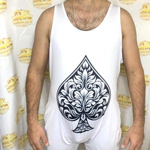 May include: A white ceramic mug with a black handle and the text "But First, Coffee" in a black, bold font. The mug is on a white surface.