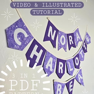 以下が含まれることがあります： 白い文字で「NORA CHARLOTTE BEA」と書かれた紫色の布製バナー。バナーは渦巻き模様で装飾されており、PDFパターンの一部です。上部のテキストは「VIDEO & ILLUSTRATED TUTORIAL」と書かれています。