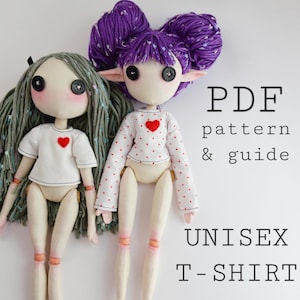 May include: Two handmade dolls with button eyes and yarn hair. One doll has long gray hair and a white t-shirt with a red heart. The other has purple hair, pointed ears, and a white long-sleeve shirt with red dots and a heart. Text reads: PDF pattern & guide UNISEX T-SHIRT.