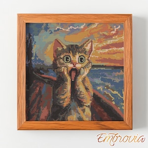 May include: Cross-stitch art in a wooden frame depicts a cat with a shocked expression, mimicking Edvard Munch's "The Scream." The background features a sunset over water. The artwork is signed "Embrovia."