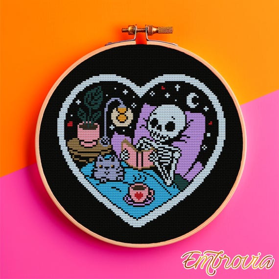 Cozy Afterlife Reading Nook. Heart-frame skeleton with cat and tea • 100×91 stitches • instant PDF chart for pastel goth, bookish cozy decor